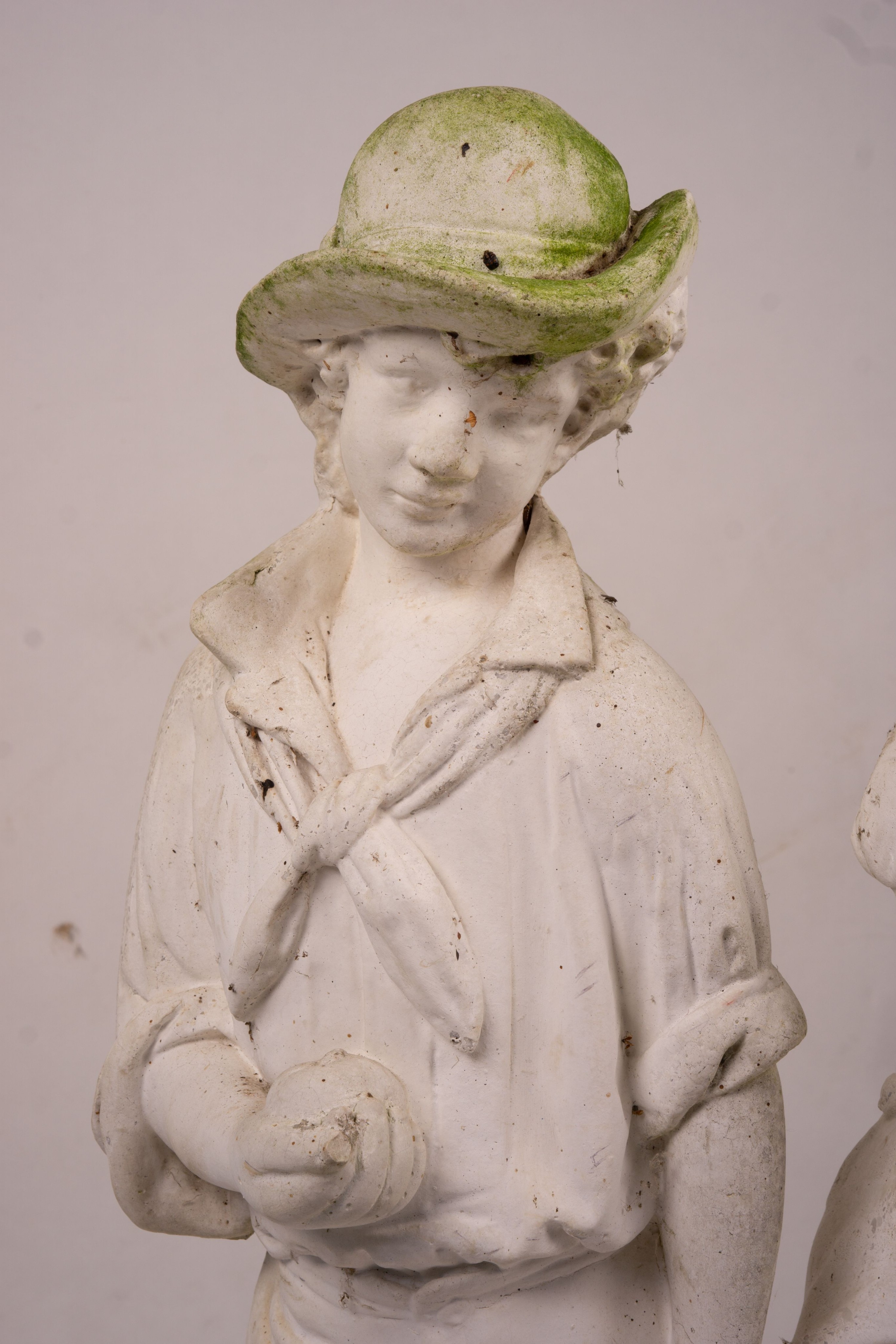 A reconstituted stone garden ornament of fruit and flower pickers, height 89cm